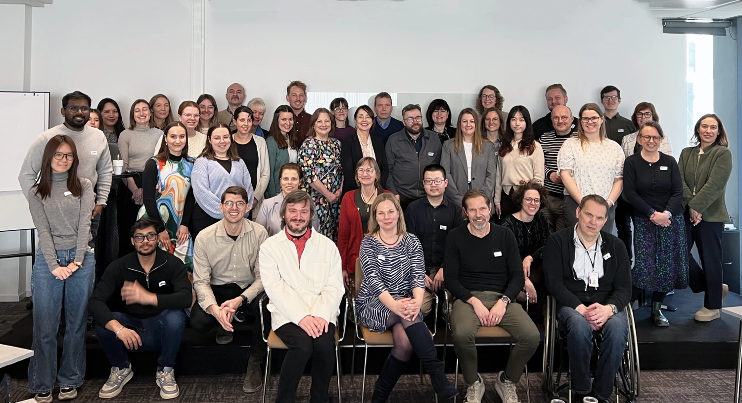 About 40 people in a group picture.