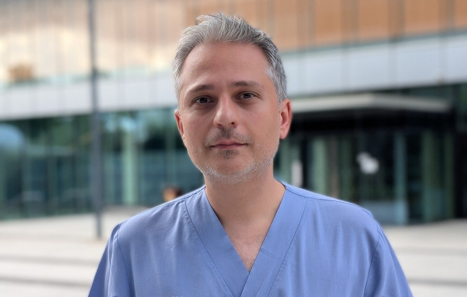 Portrait of Alexios Matikas in blie scrubs