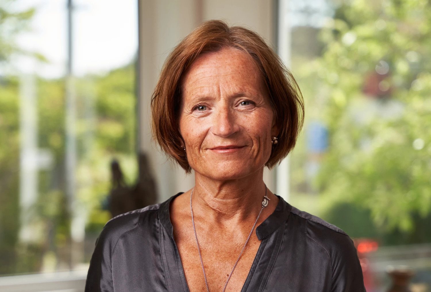 A women standing in a clinical setting.