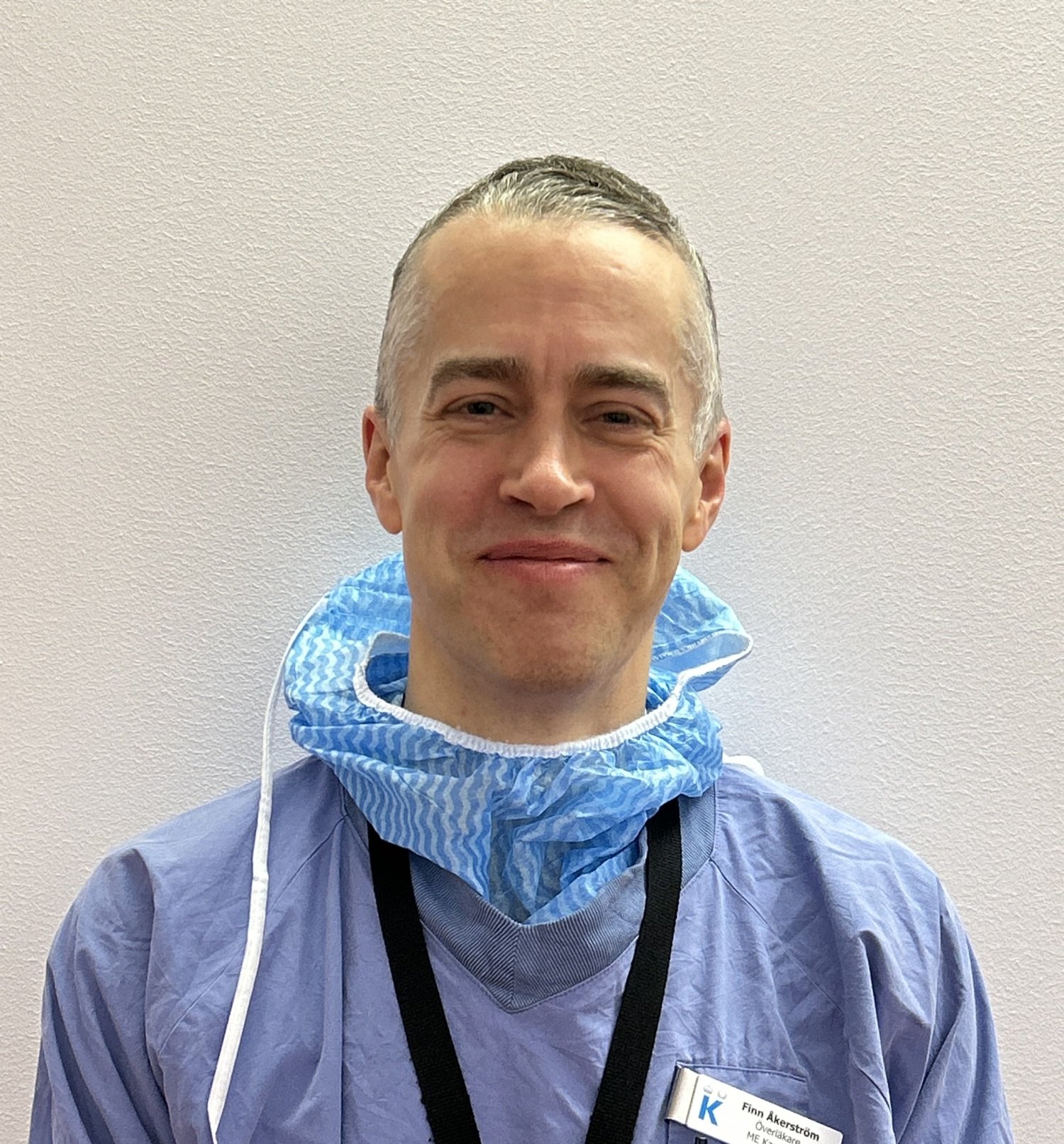 Portrait of smiling man in medical attire.