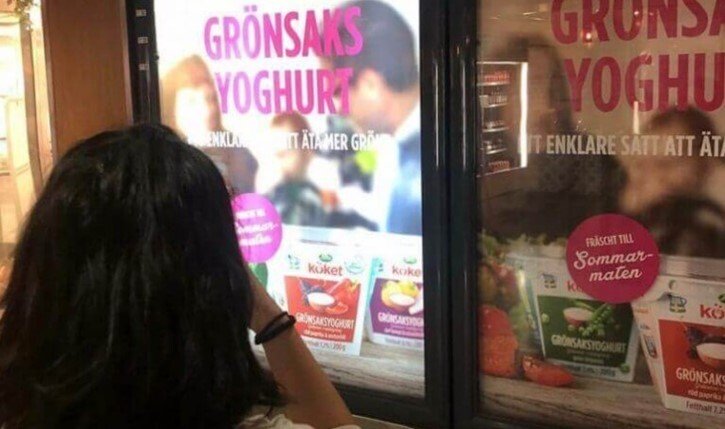 Person taking a photo of food advertisement in research project