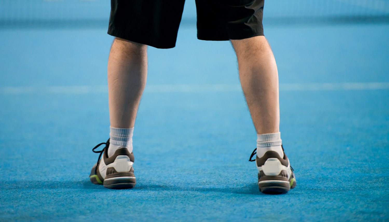 Feet on tennis court