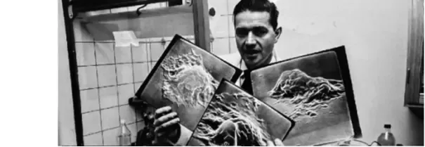 Photo of Lennart Nilsson holding three photos.