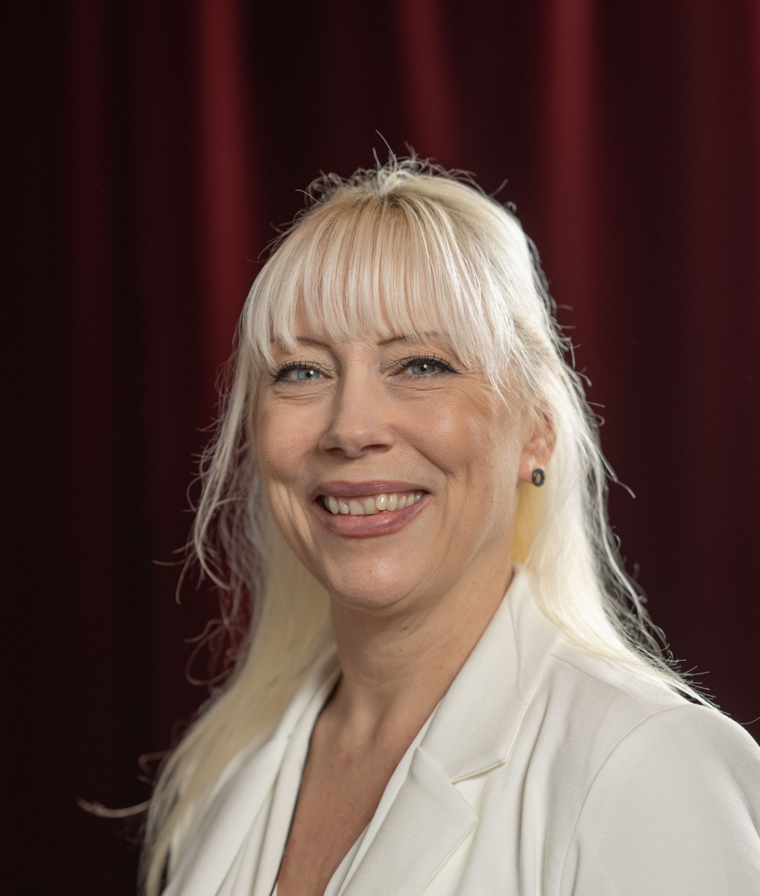 Portrait of smiling, blonde woman.