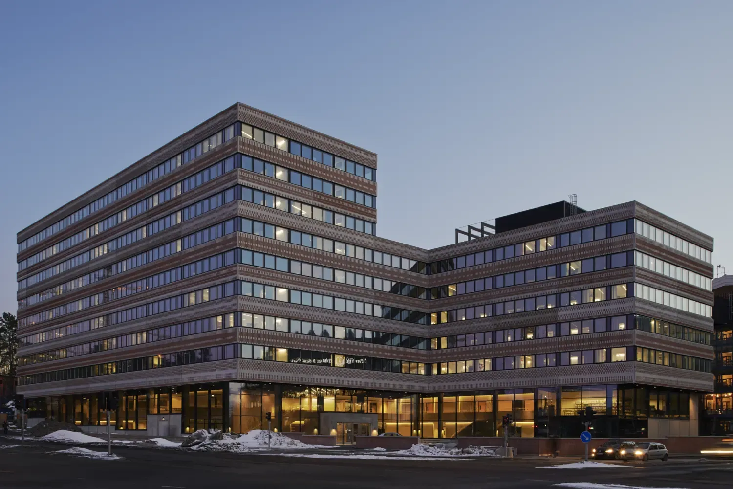 The exterior of the Widerström building during the evening with snow outside.