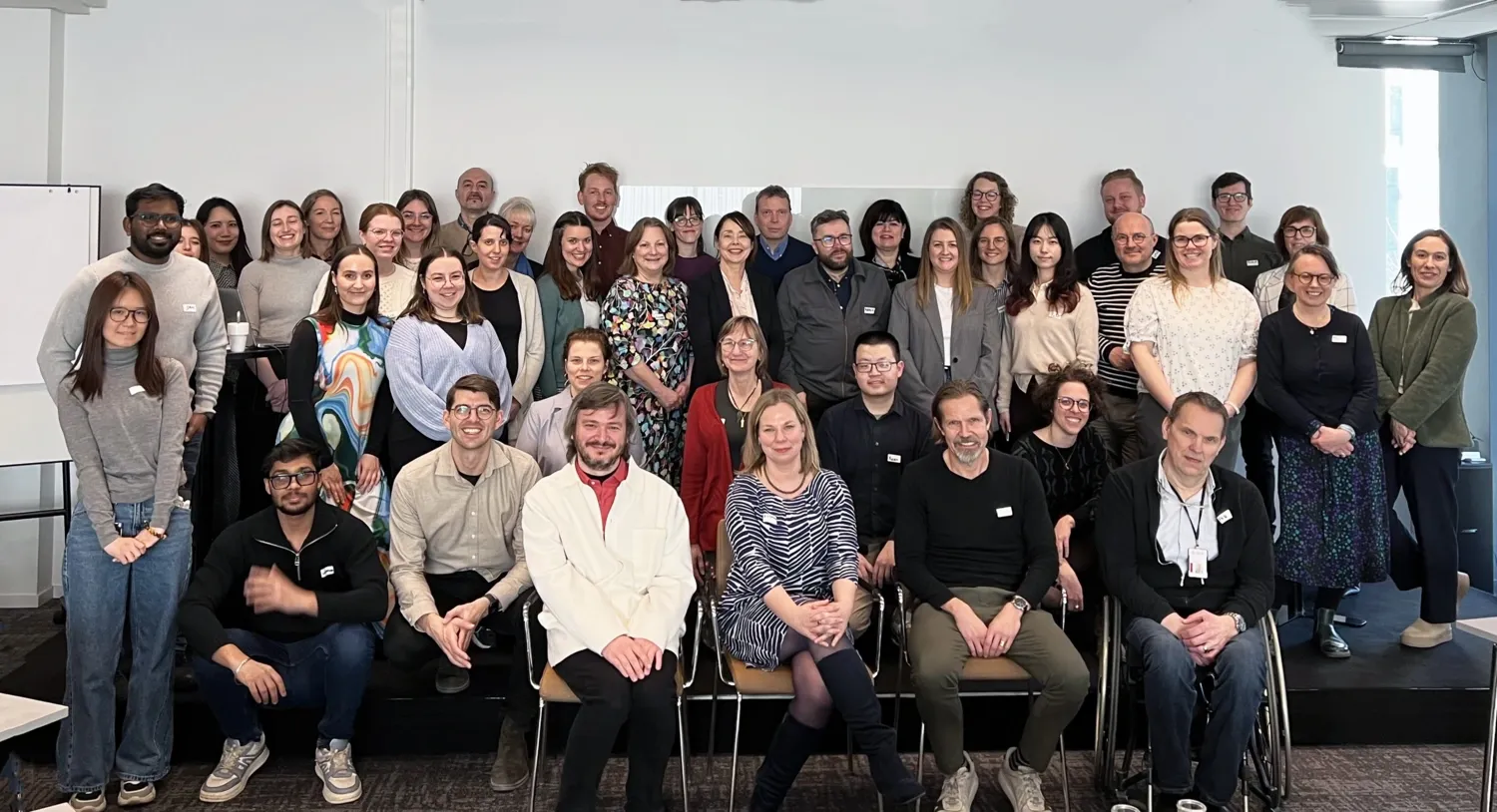 About 40 people in a group picture.