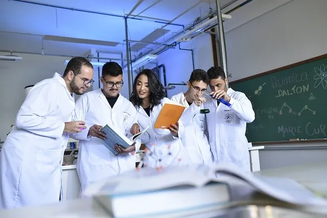 Scientists in white coats reading