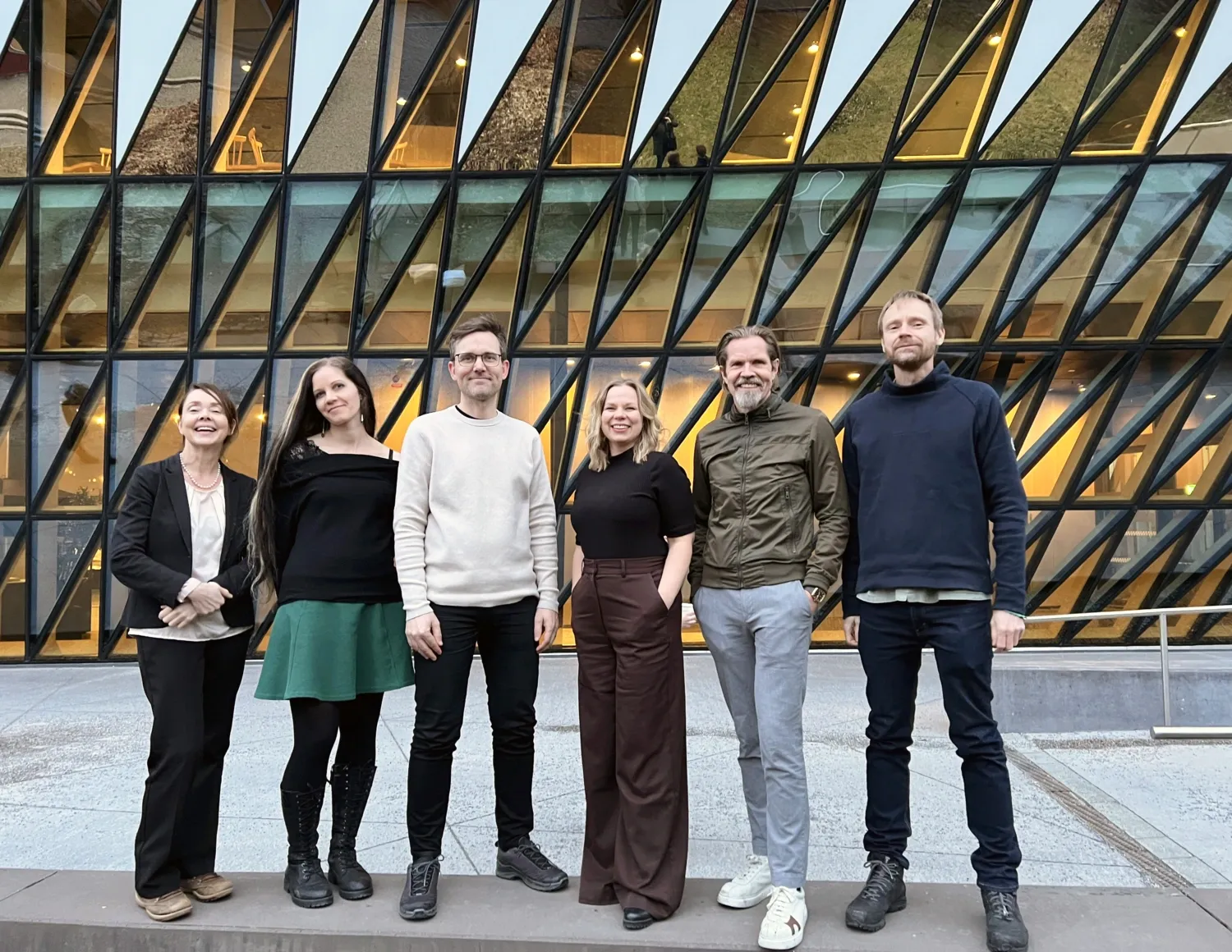 Three men and three women standing outside