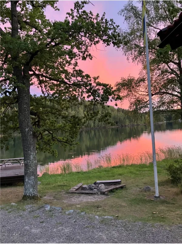 A pink/orange sunset over a lake.