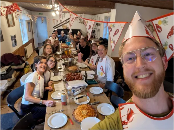 A group selfie of all members at the retreat enjoying a crayfish dinner.