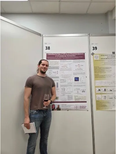 Man standing in front of a poster depicting his current research project