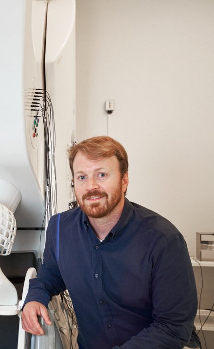 Daniel Lundqvist och Christoph Pfeiffer sitter vid två dockor med On-scalp MEG på huvudet.