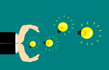 two hands catching light bulbs