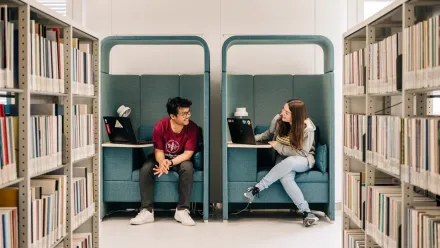 Two students studying at the university library in Solna.
