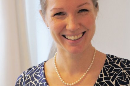 Portrait against a neutral background.